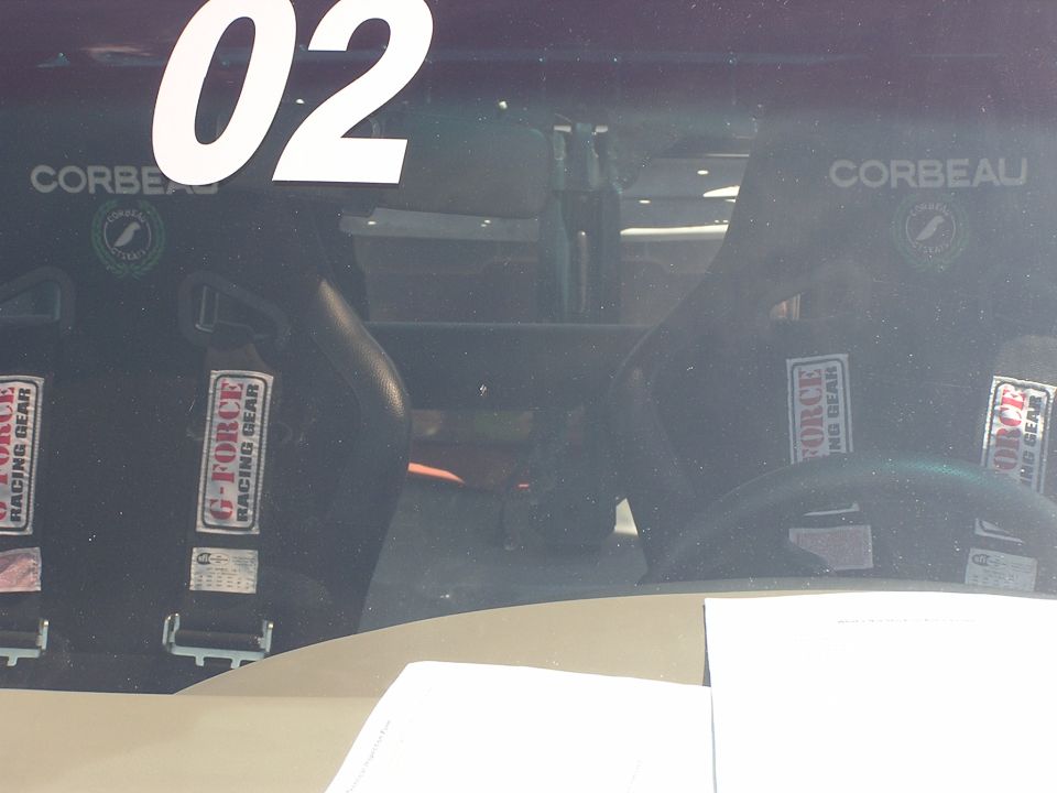 Interior view of racing seats with Corbeau branding and G-Force racing harnesses