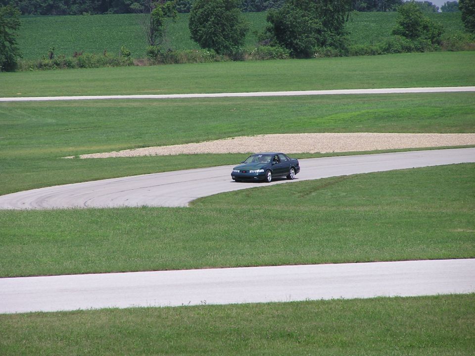 Dark green 1993 Ford Taurus on a race track, 3q-front view
