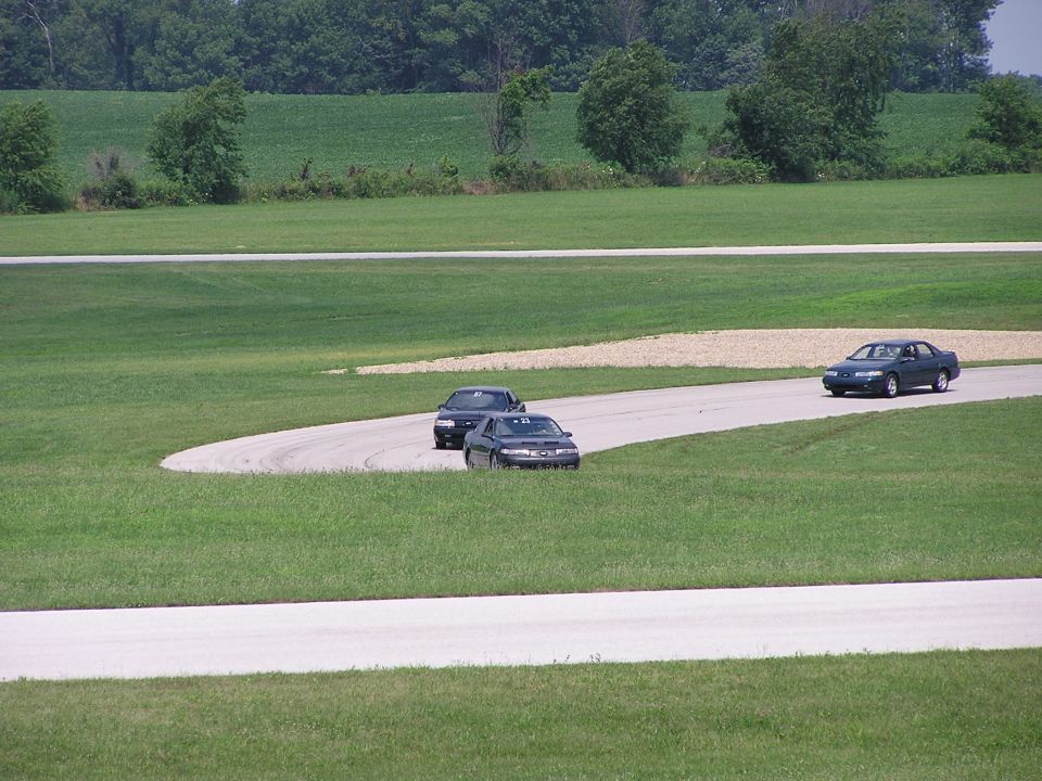 Dark green 1993 Ford Taurus on a race track, 3q-front view