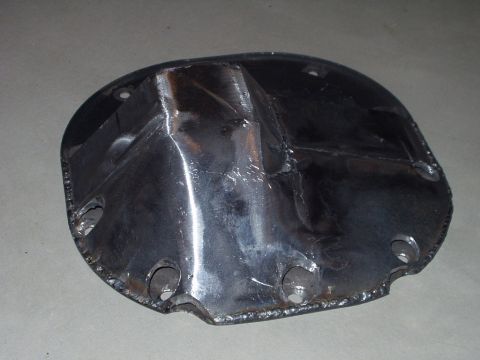 1993 Ford Bronco - A custom metal differential cover is shown, with rough welds and mounting holes.