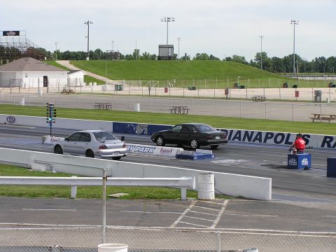 1993 Ford Taurus - Drag race in progress at Indianapolis Raceway Park, with two sedans lined up.