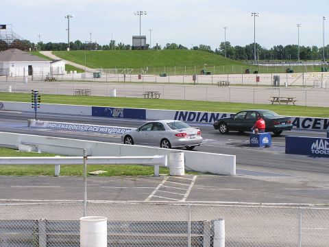 1993 Ford Taurus - Two sedans are lined up on a drag strip at Indianapolis Raceway Park.