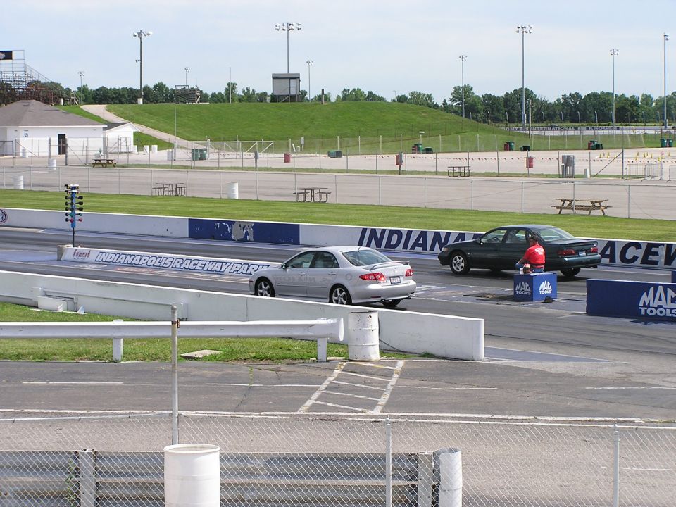 Silver sedan and dark sedan on Indianapolis Raceway Park drag strip
