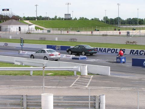 1993 Ford Taurus - Two sedans race down the drag strip at Indianapolis Raceway Park.