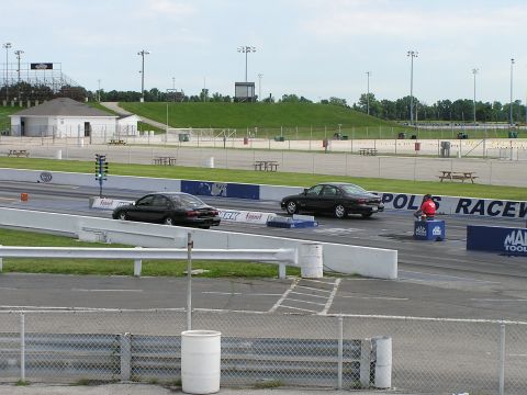 1993 Ford Taurus - Two Ford Taurus sedans are lined up on a drag strip, preparing for a race.