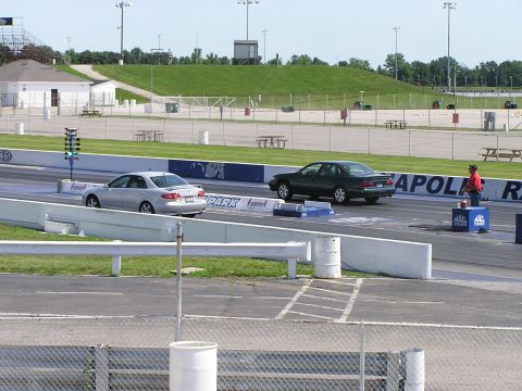 1993 Ford Taurus - A drag race is about to begin with two sedans staged on the track, awaiting the start signal.