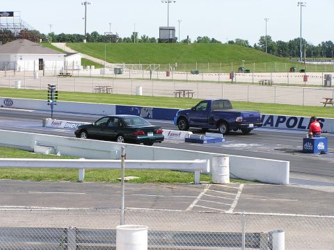 1993 Ford Taurus - Two vehicles prepare for a drag race on a sunny day at the Indianapolis Motor Speedway.
