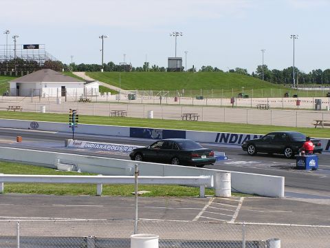 1993 Ford Taurus - Cars race down the drag strip at Indianapolis Raceway on a clear day.