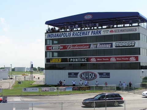 1993 Ford Taurus - Indianapolis Raceway Park building displays various sponsor logos under a bright blue sky.