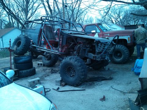 1986 Ford Bronco - Custom off-road buggy project in progress, with a red pickup truck visible behind it.