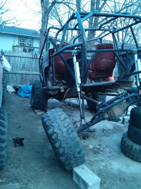 1986 Ford Bronco - This heavily modified off-road vehicle features a custom roll cage and oversized tires, suggesting extensive customization beyond its origi…