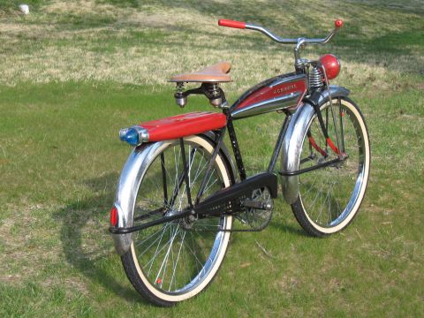 1994 Ford Bronco - A vintage bicycle with a red tank and fender light sits on a grassy lawn.