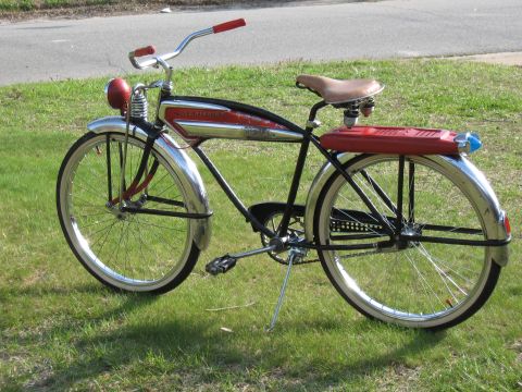 1994 Ford Bronco - A vintage bicycle with a red rear rack and a red headlight sits on grass.
