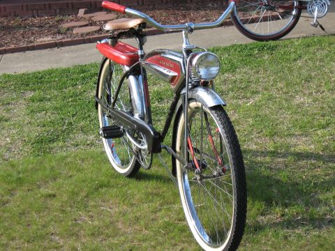1994 Ford Bronco - A vintage red and chrome Schwinn bicycle is parked on grass, with another bicycle visible in the background.