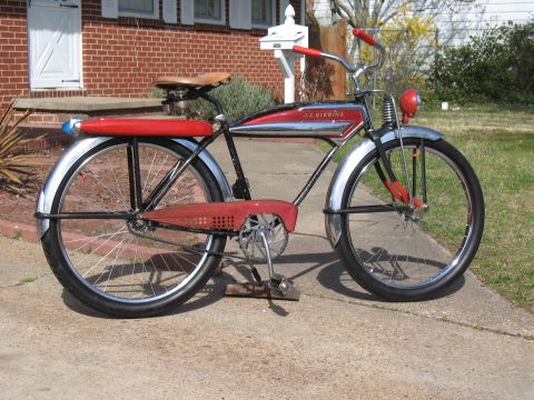 1994 Ford Bronco - Vintage J.C. Higgins bicycle parked on a sidewalk in front of a brick house.