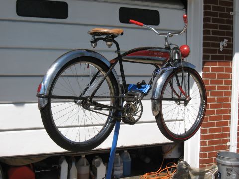 1994 Ford Bronco - A vintage bicycle with chrome fenders and red accents is displayed against a garage door.