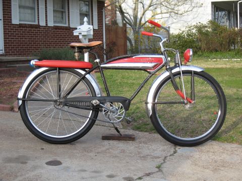 1994 Ford Bronco - A vintage Schwinn bicycle with a red seat and red handlebars is parked on a driveway.