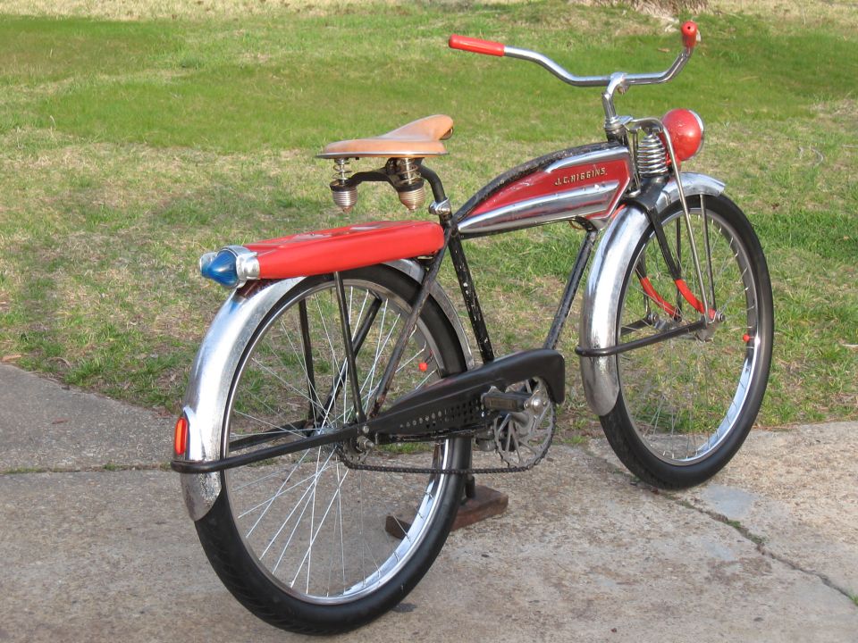 Red and chrome bicycle with J.C. Higgins branding and a red rear rack