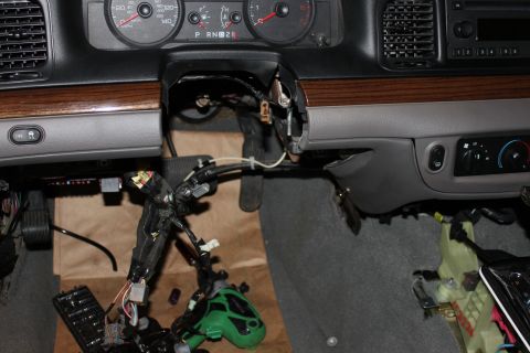 2007 Ford Crown Victoria - The interior dashboard wiring harness of a 2007 Ford Crown Victoria is exposed, indicating a repair or modification is underway.