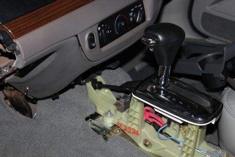 2007 Ford Crown Victoria - Disassembled center console and gear shifter assembly from a 2007 Ford Crown Victoria.