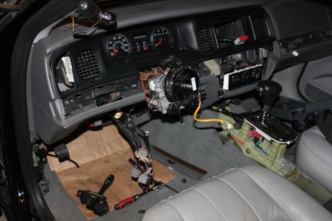 2007 Ford Crown Victoria - The interior of a 2007 Ford Crown Victoria is shown with the dashboard and steering column disassembled for repair.