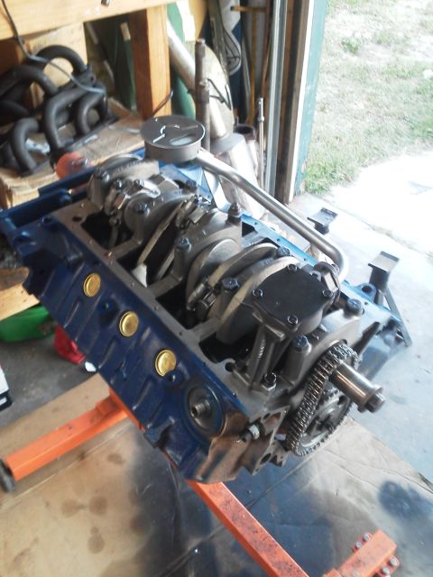 1988 Ford Bronco - A blue Ford V8 engine block is mounted on an orange engine stand, with internal components visible.
