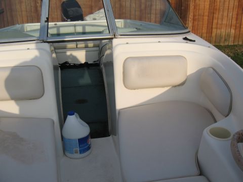 1994 Ford Bronco - Interior view of a boat, showing seating, a cup holder, and a bottle of cleaning solution.