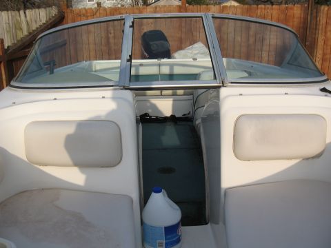1994 Ford Bronco - Interior view of a boat, showing seating and a wooden fence behind it.