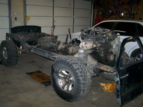1988 Suzuki Samurai - This vehicle is undergoing a major mechanical overhaul, with the engine and frame exposed.