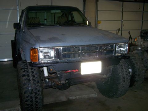 1988 Suzuki Samurai - This Toyota pickup truck features oversized tires and a modified front bumper, suggesting off-road modifications.