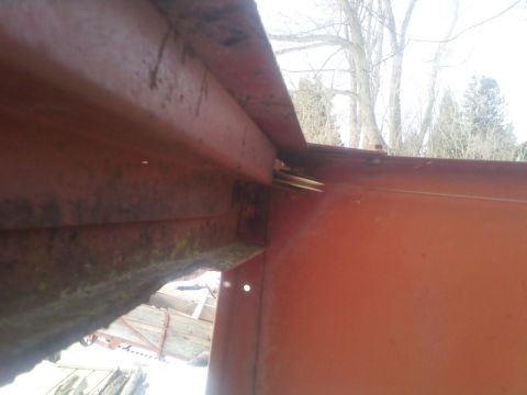 1987 Ford F-250 - Close-up view of a rusted metal frame, showing structural components and bracing.