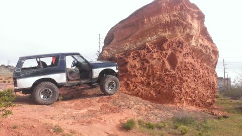 1994 Ford Bronco - Modified Ford Bronco navigates rocky terrain with its doors off.