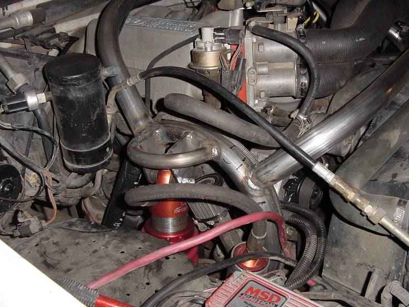 Engine bay with stainless headers, red oil filter mount, and MSD ignition box
