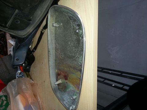 1994 Ford Bronco - A detached chrome trim piece, possibly from a vehicle, is shown with its mounting hardware visible.
