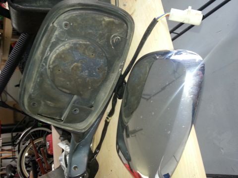 1994 Ford Bronco - Side mirror assembly disassembled, revealing the internal components and exterior housing.