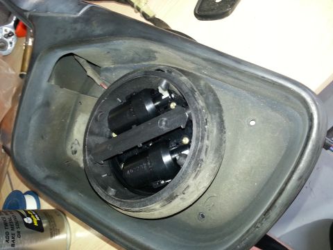 1994 Ford Bronco - Close-up of a disassembled side mirror assembly, showing the internal wiring and motor components.