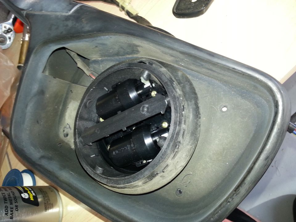 disassembled side mirror housing with internal electrical components visible