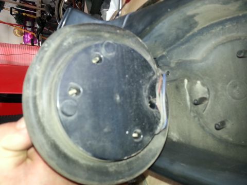 1994 Ford Bronco - This image shows a close-up of a vehicle mirror assembly part, revealing wiring and mounting points.