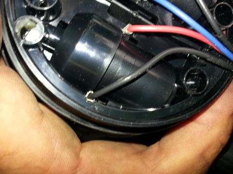 1994 Ford Bronco - Internal view of a black plastic component showing wiring connections, including red and blue wires.