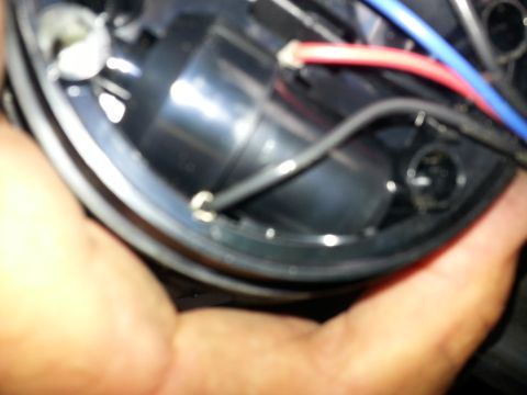 1994 Ford Bronco - Wiring detail within a vehicle's headlight assembly.
