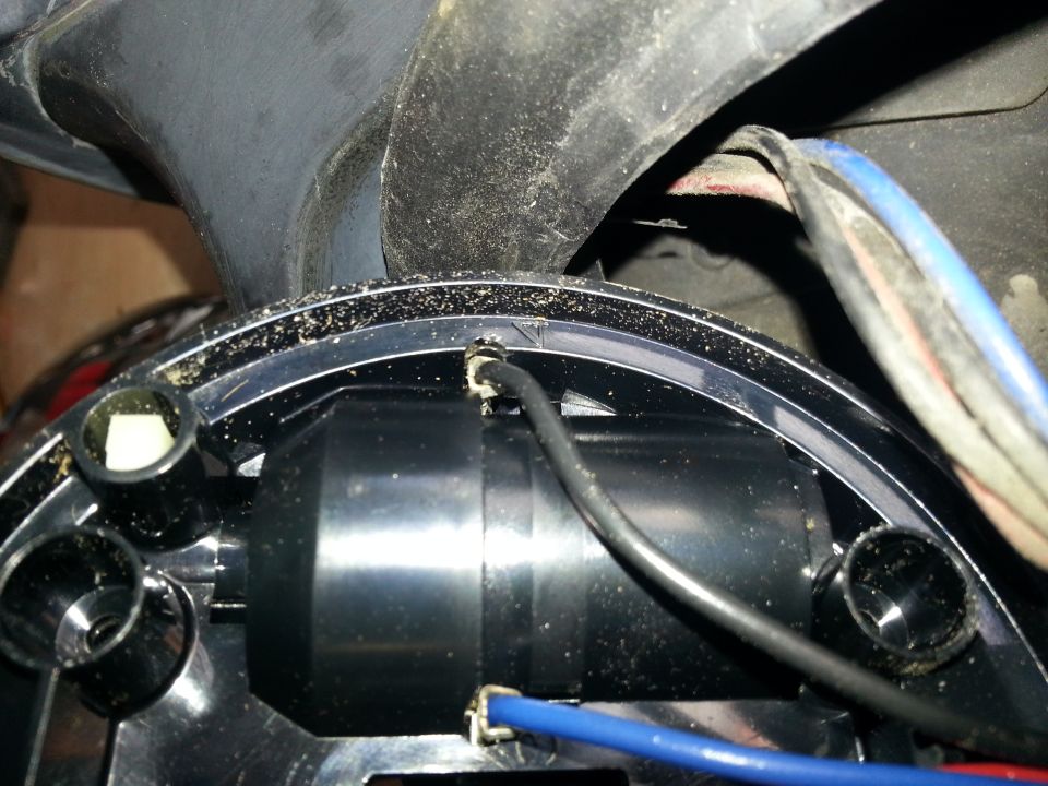Close-up of automotive part with black and blue wires connected