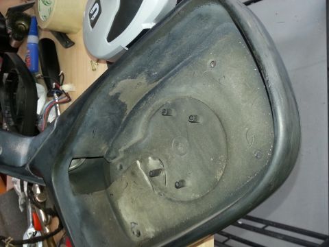 1994 Ford Bronco - Interior of a dusty black plastic car mirror housing with visible mounting studs.