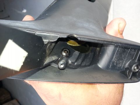 1994 Ford Bronco - Close-up of a car mirror housing, showing internal components and mounting points.