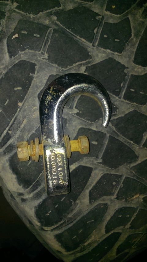 1994 Ford Bronco - A tow hook is shown resting on the tread of a tire, with its maximum load capacity visible.