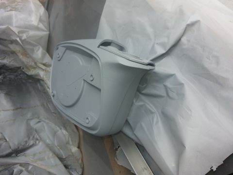 1994 Ford Bronco - A gray automotive part, likely a steering wheel hub or similar component, is prepared for hydrographic application.