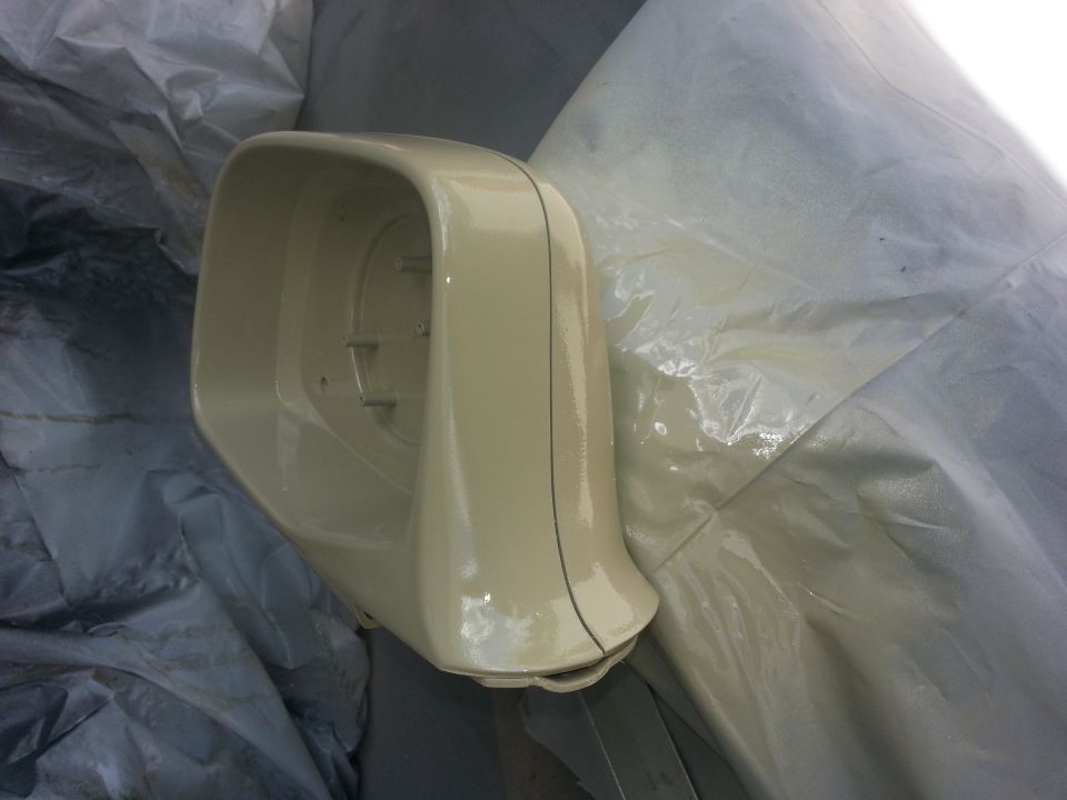 Beige side mirror housing on a tarp