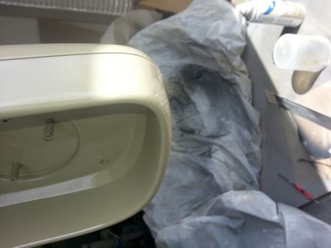1994 Ford Bronco - A beige car side mirror is shown in detail, with background items covered by a cloth.