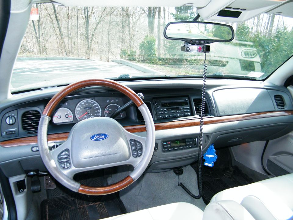 Interior of a 2004 Ford Crown Victoria, showing the dashboard, steering wheel, and center console