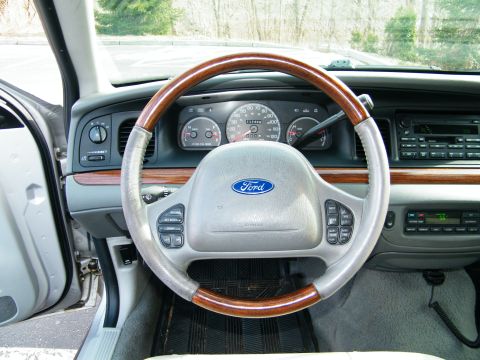 2004 Ford Crown Victoria - Interior view of a 2004 Ford Crown Victoria, highlighting the dashboard and steering wheel.