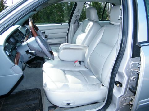 2004 Ford Crown Victoria - Interior view of a 2004 Ford Crown Victoria, highlighting the front seats and dashboard.